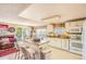 Open kitchen layout with an island, white appliances, and seamless connection to the dining area at 4276 S Tempe Ct, Aurora, CO 80018
