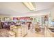 Bright open floor plan featuring an island, seating, and living room combo with sliding doors at 4276 S Tempe Ct, Aurora, CO 80018