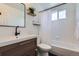 Modern bathroom with floating shelves, a stylish vanity, and a shower-tub combo at 4620 E 135Th Way, Thornton, CO 80241