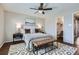 Comfortable bedroom with a ceiling fan and en-suite bathroom at 4620 E 135Th Way, Thornton, CO 80241