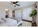 Bedroom featuring a ceiling fan, closet space, and a view to the en-suite bathroom at 4620 E 135Th Way, Thornton, CO 80241