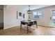 Dining room featuring stylish lighting, wood floors, and a view of the backyard at 4620 E 135Th Way, Thornton, CO 80241