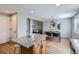 Bright kitchen open to dining area featuring a large center island and modern light fixtures at 4620 E 135Th Way, Thornton, CO 80241