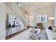 Bright living room with high ceilings, a modern staircase, and comfortable seating area at 4620 E 135Th Way, Thornton, CO 80241