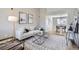 Bright living room with modern decor, stylish rug, and adjacent dining space at 4620 E 135Th Way, Thornton, CO 80241