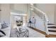 Inviting living room featuring hardwood floors and a staircase with white banisters, leading to upper level at 4620 E 135Th Way, Thornton, CO 80241