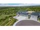 Aerial view of a two-story home with a three-car garage and circular driveway in a landscaped yard at 3459 Hotpepper Way, Castle Rock, CO 80108