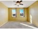 Bright bedroom with carpet, ceiling fan and two windows at 9343 Amison Cir # 103, Parker, CO 80134