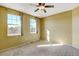 Spacious bedroom with neutral walls and ceiling fan at 9343 Amison Cir # 103, Parker, CO 80134