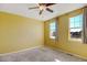 Bright bedroom with carpet, ceiling fan and two windows at 9343 Amison Cir # 103, Parker, CO 80134