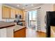 Modern kitchen featuring wood cabinets, stainless steel appliances, and a breakfast bar at 9343 Amison Cir # 103, Parker, CO 80134