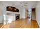 Living room with hardwood floors, fireplace, and ceiling fan at 9343 Amison Cir # 103, Parker, CO 80134