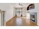 Living room with hardwood floors, fireplace, and ceiling fan at 9343 Amison Cir # 103, Parker, CO 80134