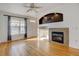 Living room with hardwood floors, fireplace, and ceiling fan at 9343 Amison Cir # 103, Parker, CO 80134