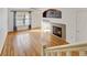 Living room with hardwood floors, fireplace, and ceiling fan at 9343 Amison Cir # 103, Parker, CO 80134