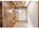 Unfinished basement with built-in shelves and exposed wood ceiling beams at 10375 E Weaver Cir, Englewood, CO 80111