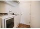 Practical laundry room with modern washer and dryer set and a white door at 10375 E Weaver Cir, Englewood, CO 80111