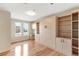 Bedroom featuring hardwood floors, city views, and a murphy bed and built-in shelves at 410 Acoma St # 605, Denver, CO 80204