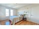 Bedroom with hardwood floors, sconce lighting, and bright windows at 410 Acoma St # 605, Denver, CO 80204