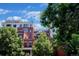 Multi-story brick building featuring balconies and surrounded by mature trees at 410 Acoma St # 605, Denver, CO 80204