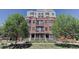 Exterior shot of building featuring brick facade, balconies and well-maintained landscaping at 410 Acoma St # 605, Denver, CO 80204