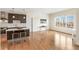 Open-concept living space with hardwood floors, kitchen island and city views at 410 Acoma St # 605, Denver, CO 80204