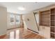 Bedroom featuring a murphy bed and built-in shelves with hardwood floors and city views at 410 Acoma St # 605, Denver, CO 80204