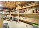 Unfinished basement area with exposed ceiling, storage shelving and work bench at 5254 Cheyenne Rd, Indian Hills, CO 80454