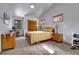 Carpeted Bedroom with a bed and three wooden frame windows at 5254 Cheyenne Rd, Indian Hills, CO 80454
