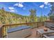 Relaxing deck with mountain views and a hot tub at 5254 Cheyenne Rd, Indian Hills, CO 80454