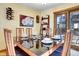 A dining room features modern furniture and a large glass table at 5254 Cheyenne Rd, Indian Hills, CO 80454