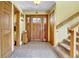 Inviting foyer features a decorative tile floor, wooden front door with sidelights, and staircase at 5254 Cheyenne Rd, Indian Hills, CO 80454