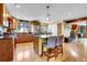 Bright kitchen with granite counters, an island, and stainless steel appliances at 5254 Cheyenne Rd, Indian Hills, CO 80454