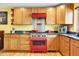 Stylish kitchen with knotty wood cabinets, black granite countertops, and stainless steel appliances at 5254 Cheyenne Rd, Indian Hills, CO 80454