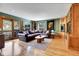 Inviting living room with a leather sectional, hardwood floors, built-in shelving, and a sliding door at 5254 Cheyenne Rd, Indian Hills, CO 80454