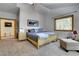 Cozy main bedroom showcasing soft carpeting, natural light from a large window, and a soothing color palette at 5254 Cheyenne Rd, Indian Hills, CO 80454