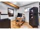 Bright office space with a wooden desk, built-in shelves, and a light-filled window at 5254 Cheyenne Rd, Indian Hills, CO 80454