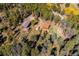 Stunning aerial view of a mountain property with a home, garage, barn, and lush trees at 28553 Birch Ln, Conifer, CO 80433