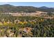 Breathtaking aerial of a home in a mountain community surrounded by trees at 28553 Birch Ln, Conifer, CO 80433