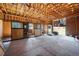 Interior view of barn stalls featuring concrete floors and wood paneling at 28553 Birch Ln, Conifer, CO 80433