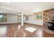 Finished basement with wood-look flooring, stone accent wall with fireplace, and natural light from windows at 28553 Birch Ln, Conifer, CO 80433