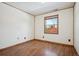 Bedroom with wood-look flooring, ample natural light, neutral walls, and convenient electrical outlets at 28553 Birch Ln, Conifer, CO 80433