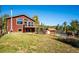 Exterior of home featuring a deck, a sloped lawn, and a shed and storage building at 28553 Birch Ln, Conifer, CO 80433