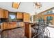 Bright kitchen features custom wood cabinets, granite countertops, copper sink, a skylight and a breakfast bar at 28553 Birch Ln, Conifer, CO 80433