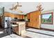 Bright kitchen featuring a kitchen island, wood cabinets and stainless steel appliances at 28553 Birch Ln, Conifer, CO 80433