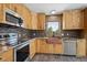 Beautiful kitchen with wood cabinets, granite countertops, stainless steel appliances and a copper sink at 28553 Birch Ln, Conifer, CO 80433