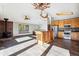 Bright living room with wood floors and a brick fireplace adjacent to the kitchen at 28553 Birch Ln, Conifer, CO 80433