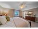 Main bedroom with large window, wooden furniture, and ceiling fan at 2776 Savage Rd, Elizabeth, CO 80107