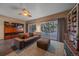 Cozy Gathering room featuring a comfy sofa, built-in shelving, and sliding glass doors at 2776 Savage Rd, Elizabeth, CO 80107