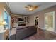 Bright living area with built-in shelving, a TV, and access to a bathroom at 2776 Savage Rd, Elizabeth, CO 80107